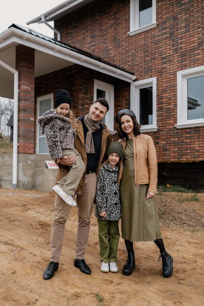 services-img Happy family posing outside their newly purchased brick house, embracing their new beginning.